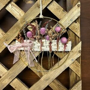 Gold wire hoop wall hanging.